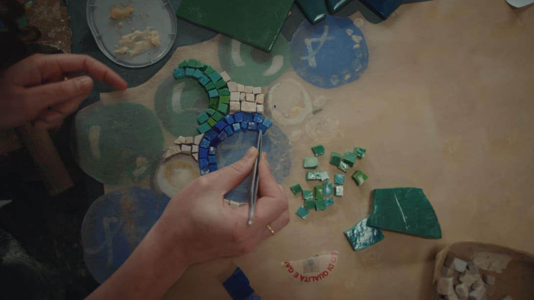 Craftsman assembling a mosaic by hand in the interiors of the Bvlgari Hotel Roma.