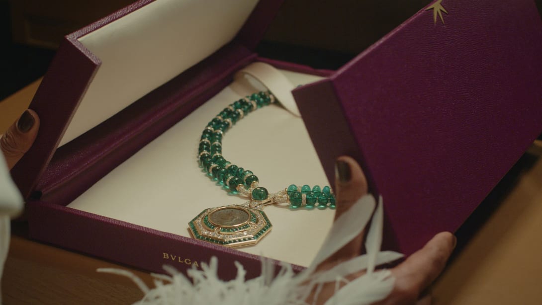 Box containing the High Jewellery necklace with emerald beads and an ancient coin featuring Augustus.