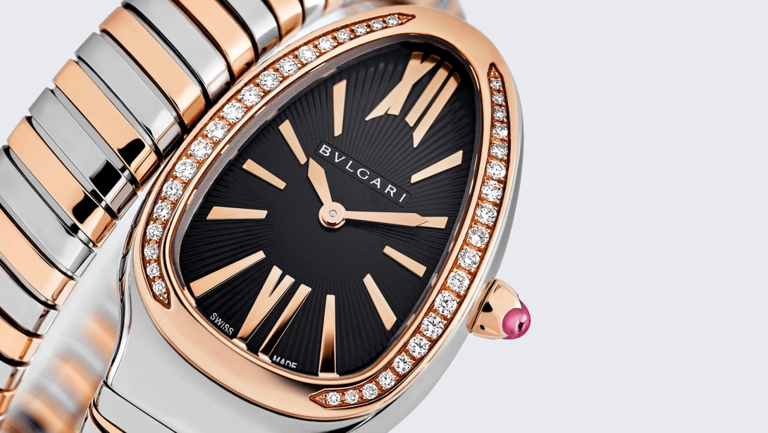 Serpenti Tubogas rose gold and steel single spiral watch with diamonds and black dial, close-up.