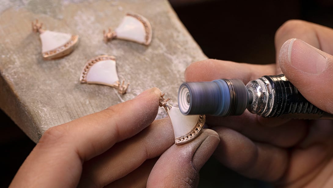 Bulgari artisan polishing a fan-shaped element of a Divas' Dream jewellery creation, close up.