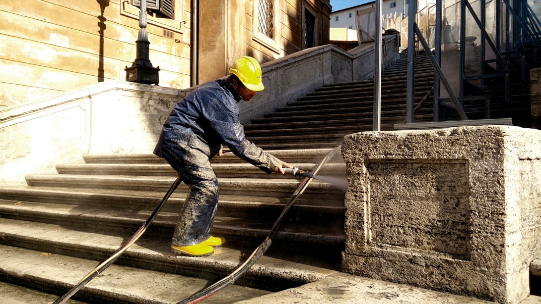 Man at work for the restoration of the Spanish Steps in Rome, financed by Bulgari as a patronage initiative.