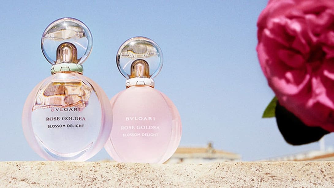 Rose Goldea Blossom Delight Eau de Parfum and Eau Toilette, Roman sky backdrop.