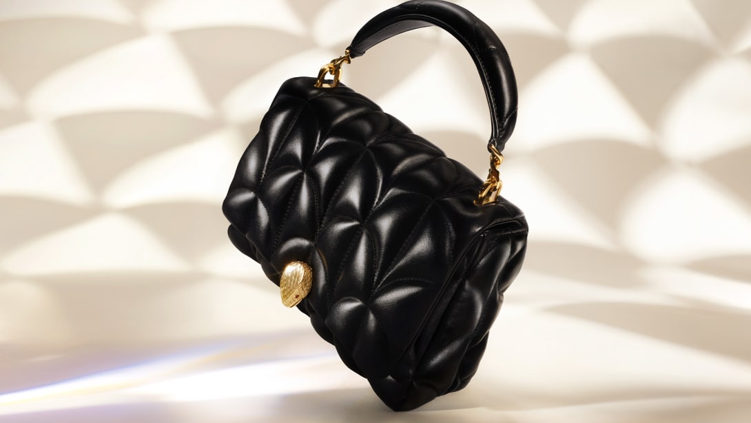 Serpenti Sugarloaf black calf leather bag with top handle, Calla Matelassé motif and snakehead closure.