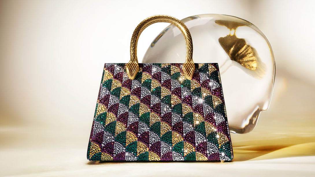 Serpentine Duo tote bag with a multi-colour pattern, Calla Crystals and handles shaped like a snake's body.