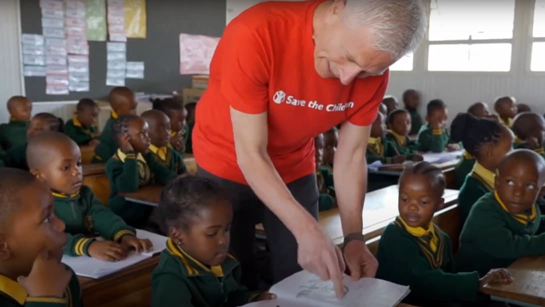 Man in a school in a Save the children project.