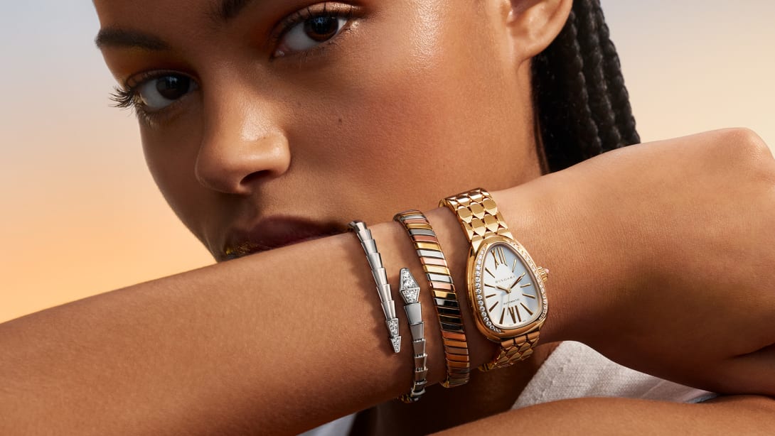 Model wearing Bvlgari Tubogas bracelet, Serpenti bracelet and watch.
