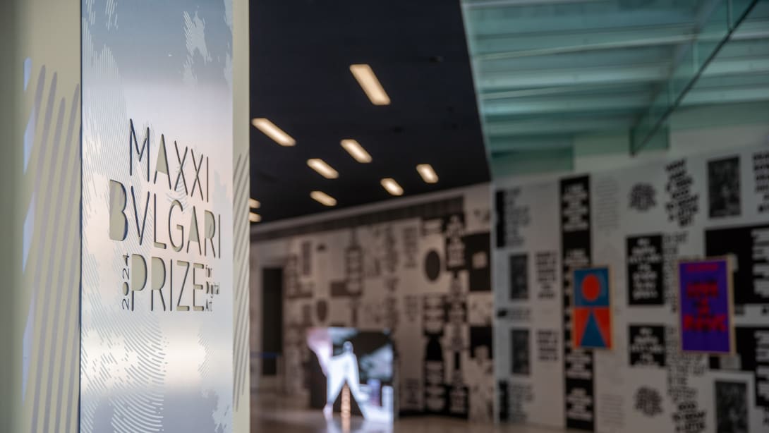 Exhibition room at MAXXI featuring a plaque with the MAXXI Bvlgari Prize inscription at the entrance.