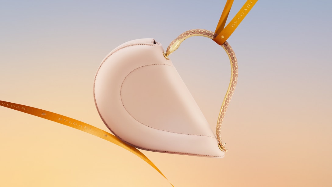 Bvlgari Serpenti Cuore 1968 heart-shaped light pink calf leather top-handle bag with orange ribbon.