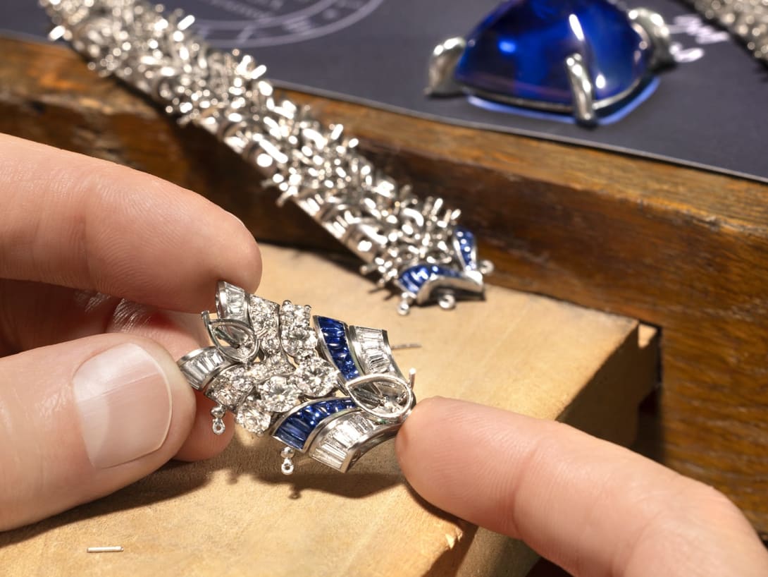 Hand holding Cosmic Vault Necklace, Polychroma High Jewellery collection.