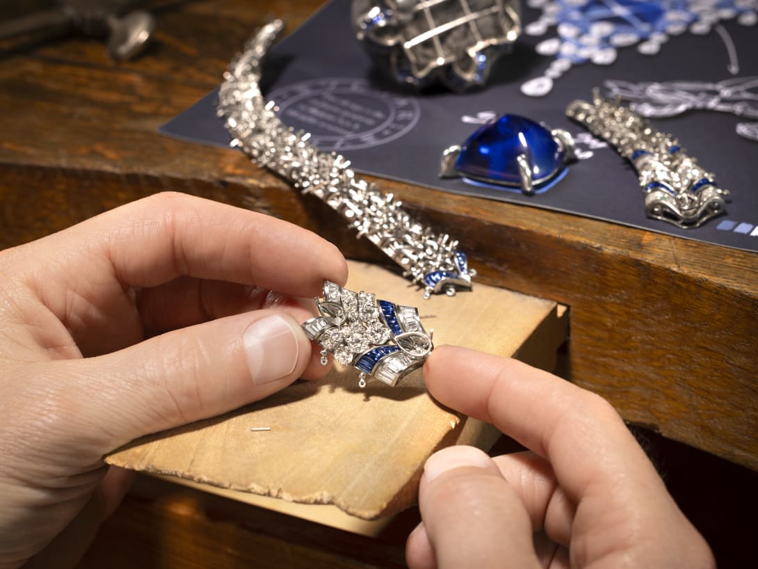 Hand holding Cosmic Vault Necklace, Polychroma High Jewellery collection.