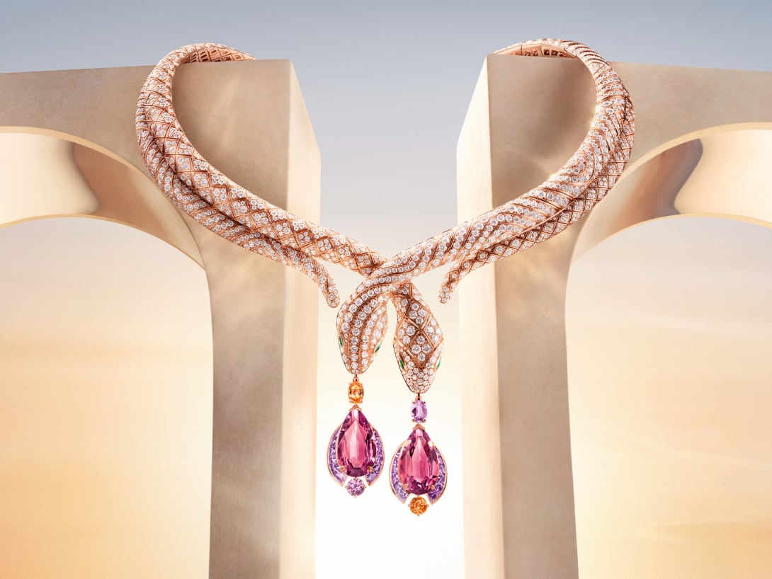Serpenti High Jewellery necklace set against Roman architectural elements, dawn sky in the background.