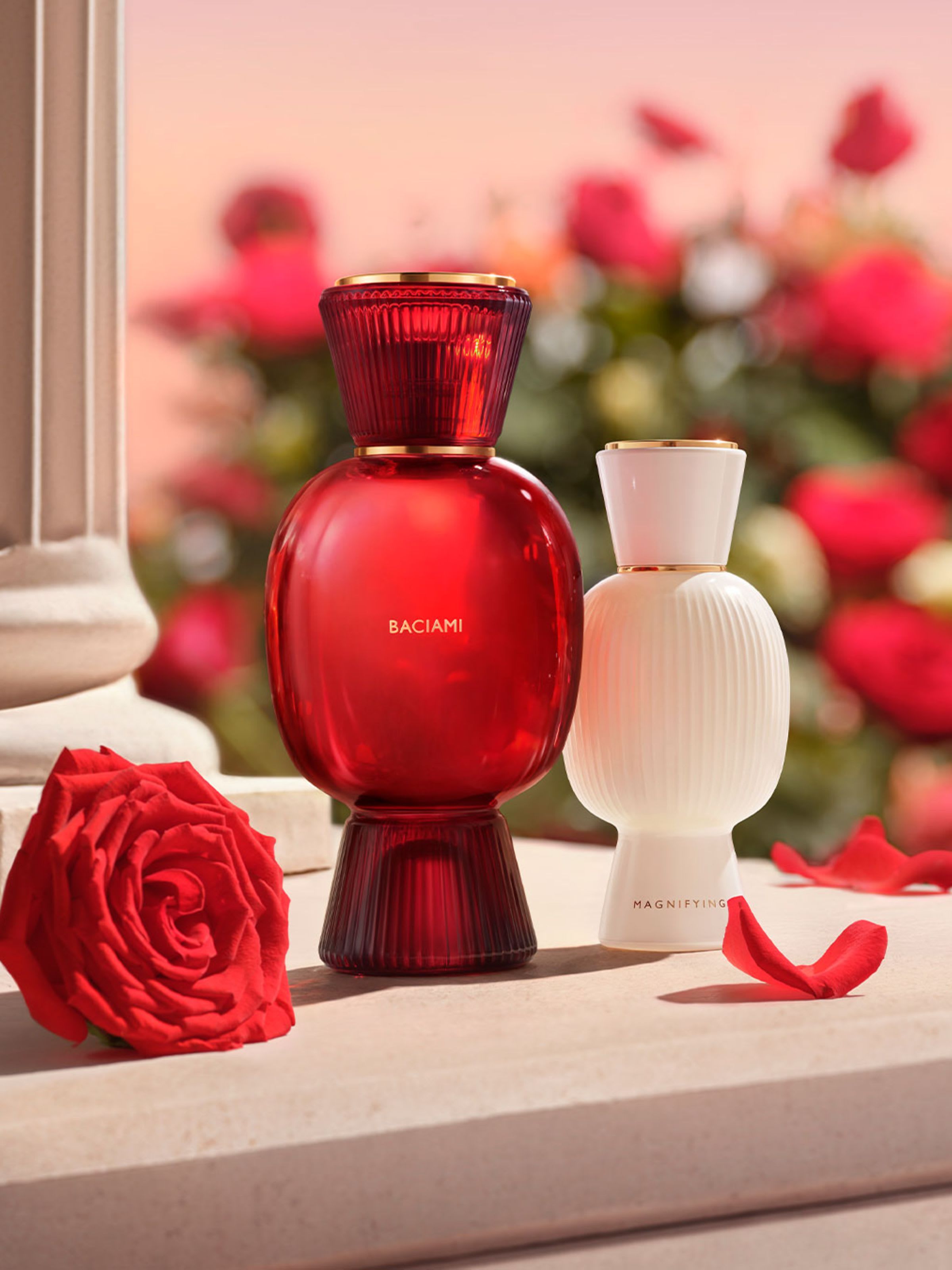 Bulgari Baciami Allegra fragrance flacon in red glass, Bulgari Allegra Magnifying Essence all-white flacon, creative shot.