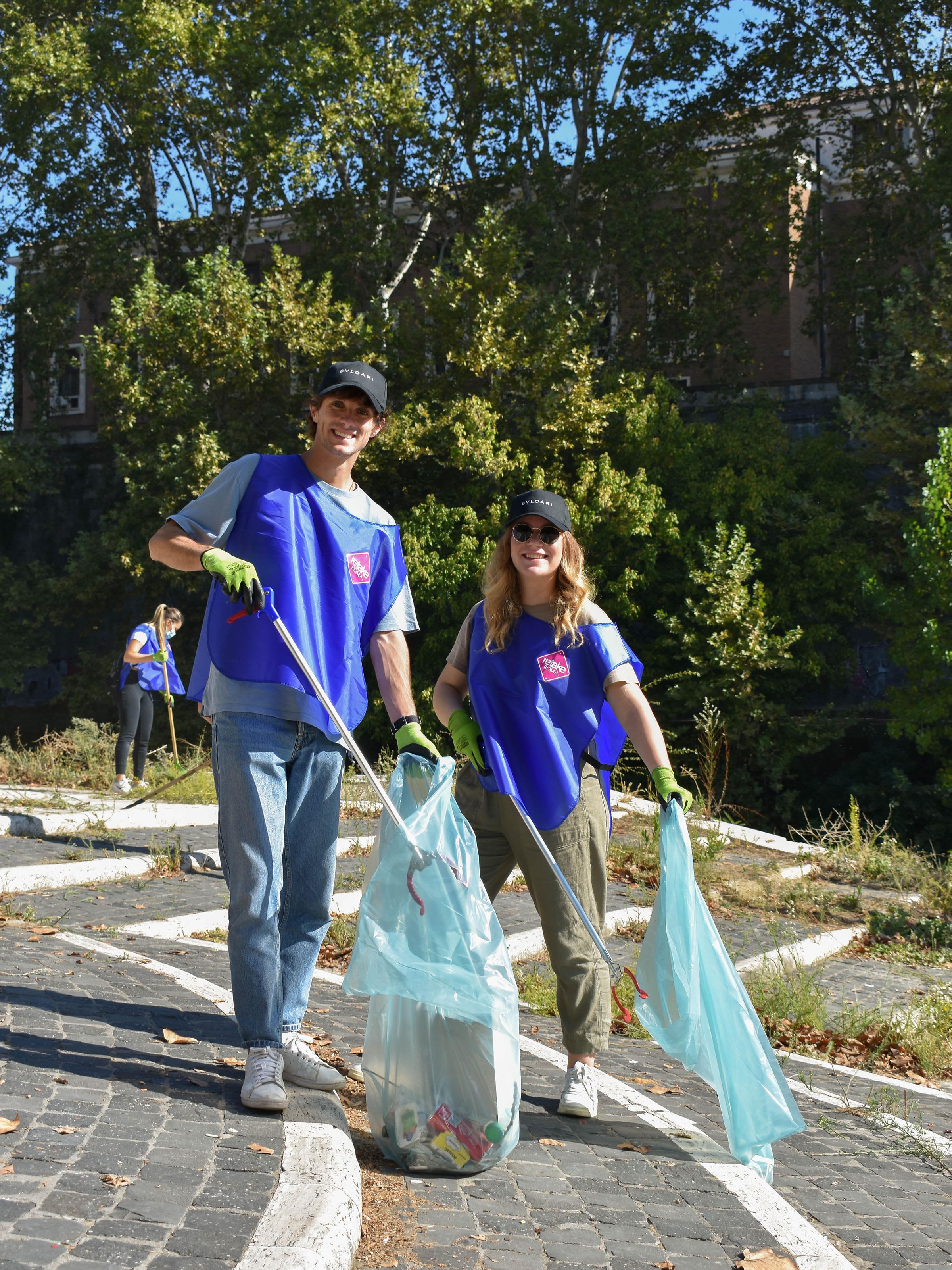Two Bulgari employees cleaning the street during the company Volunteer Day