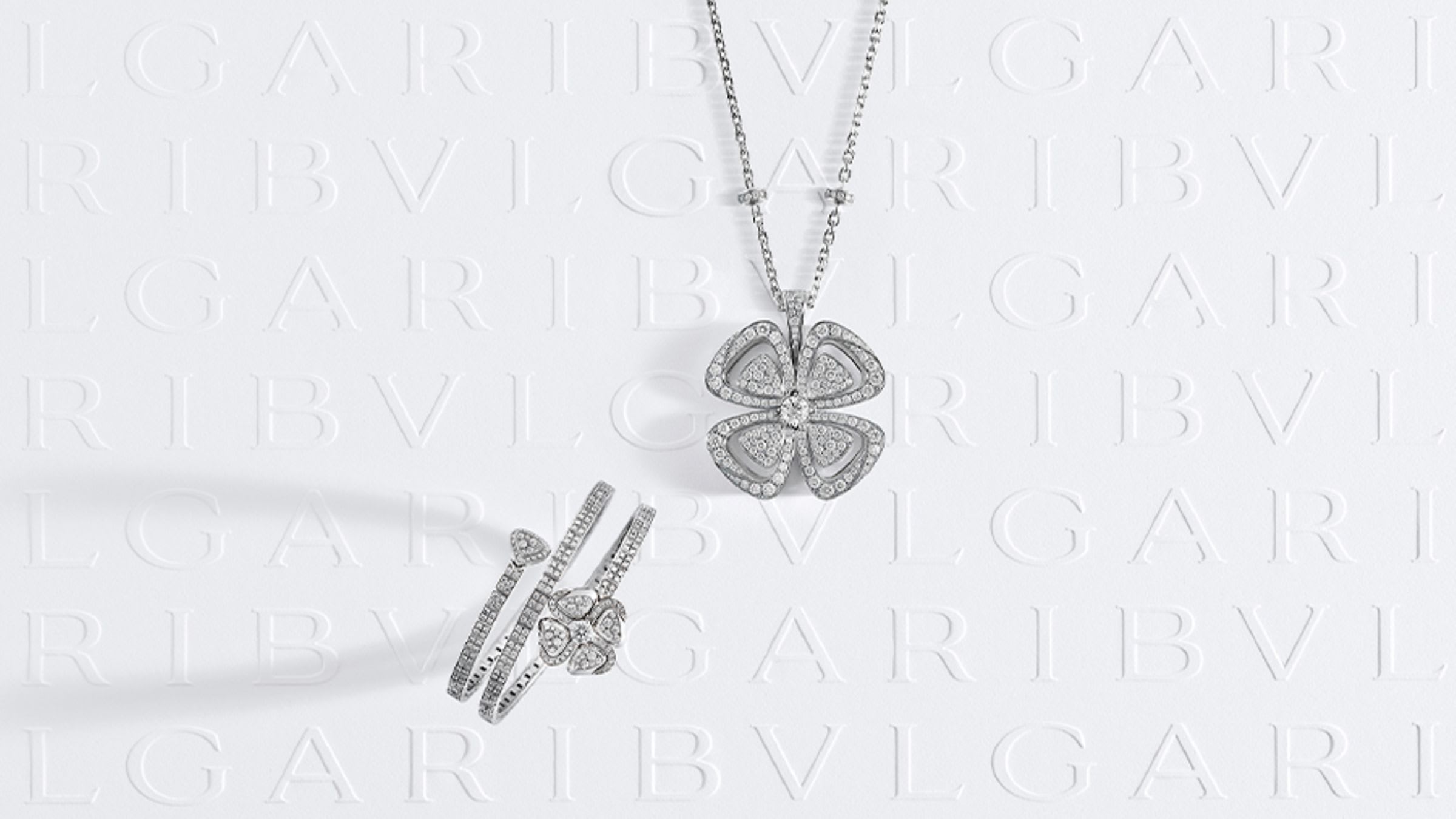 Fiorever white gold bracelet and ring with diamonds, white Bulgari logo backdrop.