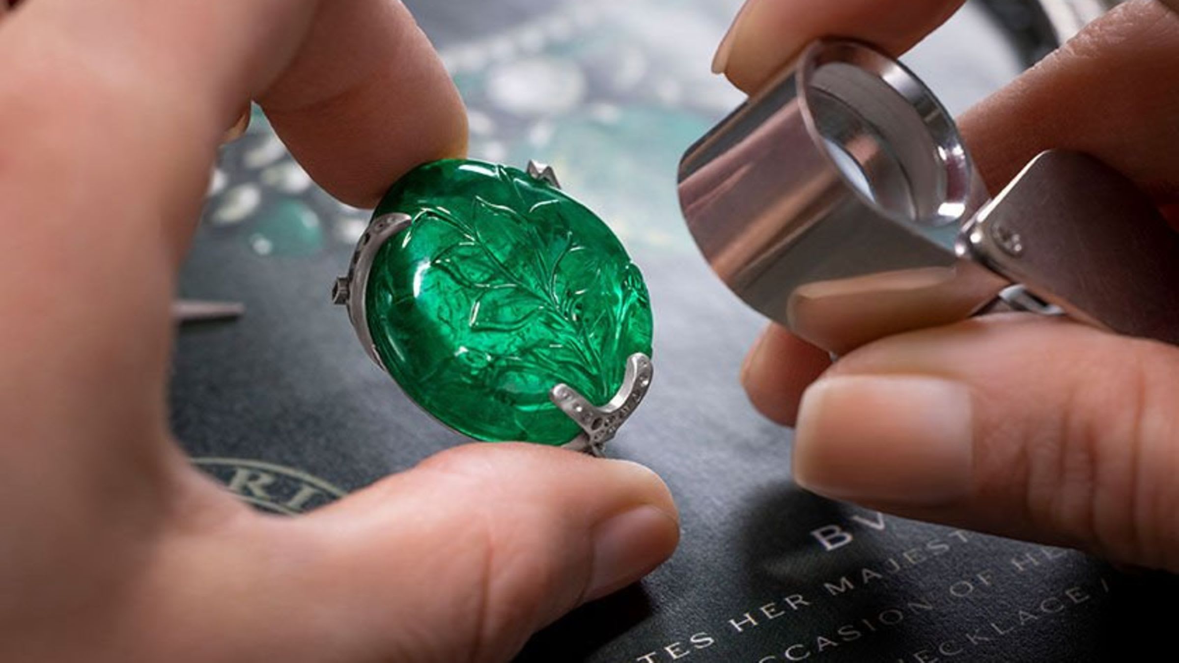 Making of the flower of the Blossoming Beauty necklace with coloured gemstones, close up of the hands.