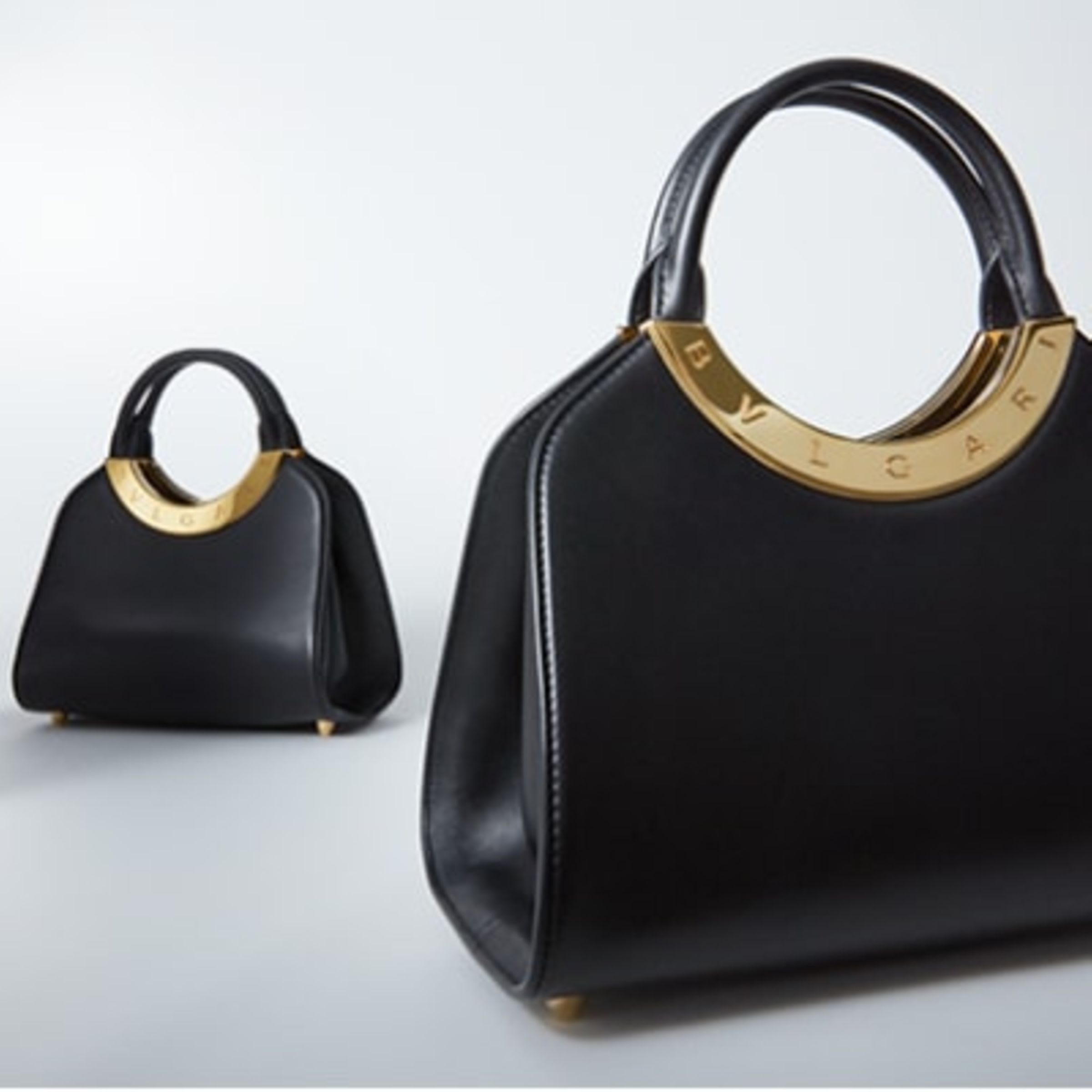 Bulgari Roma handbags in black calf leather with antique gold-plated metallic Bulgari logo frame.