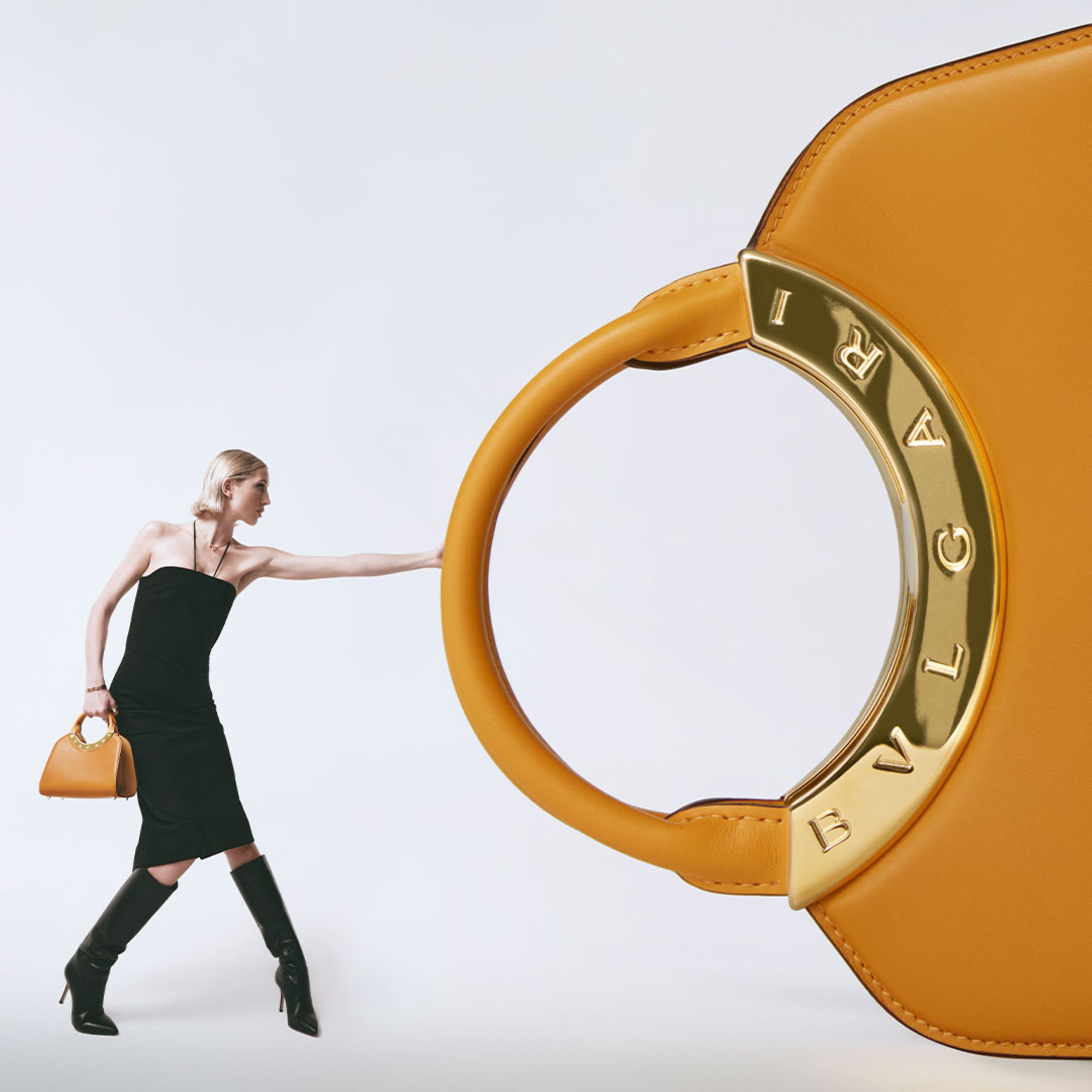 Creative shot of a model holding a Bulgari Roma calf leather bag.
