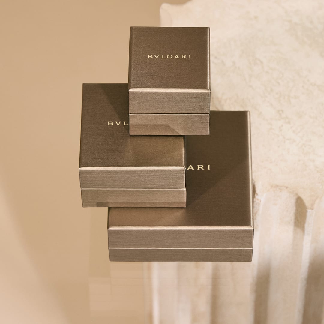 Creative shot of Bvlgari Man in Black Eau de Toilette and Eau de Parfum bottles, purple sky.